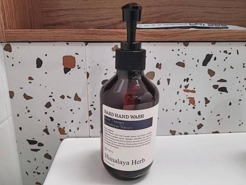 a bottle of homemade hand wash sitting on a counter at Relax-편안한영화관,130인치대형스크린,넷플,디즈니플러스,넓은객실,장기숙박추천 in Namyangju