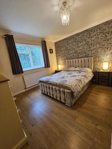a bedroom with a bed and a brick wall at Wizard's Hideaway in Leavesden Green