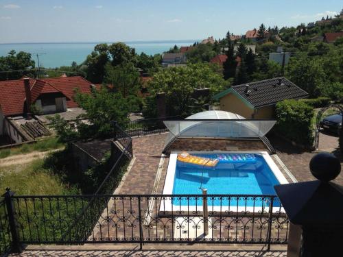 a house with a swimming pool in a yard at Balatoni Panoráma Villa in Balatonalmádi