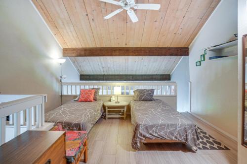 a room with two beds and a ceiling fan at Molokai Island Loft Lanai, Pool and Walk to Beach! in Kaunakakai