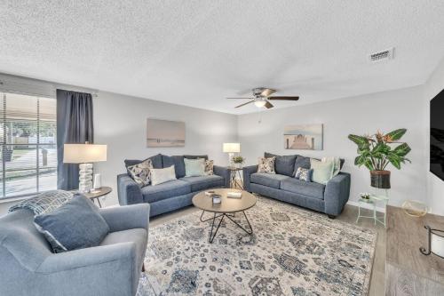 a living room with two blue couches and a table at Serenity Retreat- Charming Home Near Attractions! home in Brandon