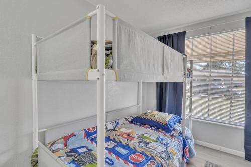 a white bunk bed in a room with a bed at Serenity Retreat- Charming Home Near Attractions! home in Brandon
