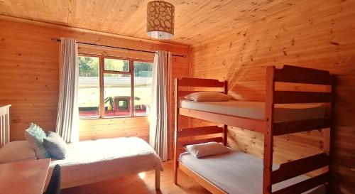 a cabin with two bunk beds and a window at Summer Villa in Mossel Bay