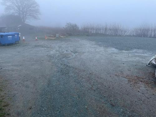 a road with ice and snow on the ground at Long Mountain Centre Log Cabins in Meadowtown