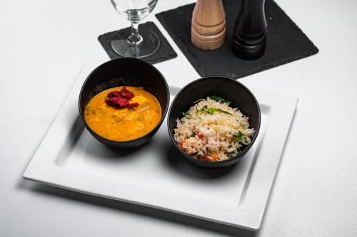 two bowls of food on a plate on a table at Šport Hotel *** Donovaly in Donovaly