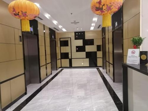 a hallway of a locker room with two chandeliers at Imperial Regency Suites & Petaling Jaya in Kuala Lumpur