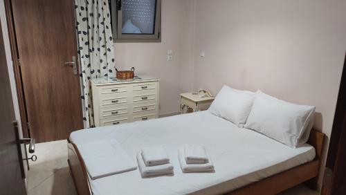 a bedroom with a bed with two towels on it at Lesvos Tavari bay 2 in Tavari