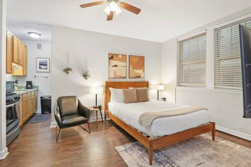 a bedroom with a bed and a chair at Trendy Studio Apartment in Chicago - Kenwood 103 & 303 rep in Chicago