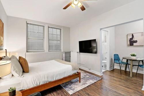 a bedroom with a bed and a flat screen tv at Trendy Studio Apartment in Chicago - Kenwood 103 & 303 rep in Chicago