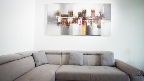 a couch in a living room with a painting on the wall at Palazzo Gilberto in Padova