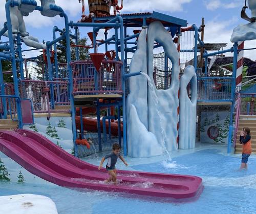 a child on a surfboard in a water park at 31R Brand new log home on quiet side street in Bethlehem, close to Main Street! 20 min to skiing in Bethlehem