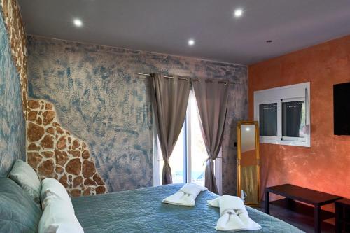 a bedroom with a bed with two towels on it at Anna Studios in Marathias