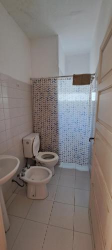 a bathroom with a toilet and a sink at Casa Bordó Villa Allende in Villa Allende