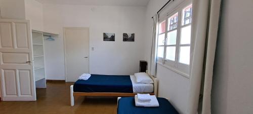a small room with two beds and a window at Casa Bordó Villa Allende in Villa Allende