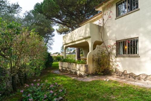 a house with a garden in front of it at Garden House in Cascais