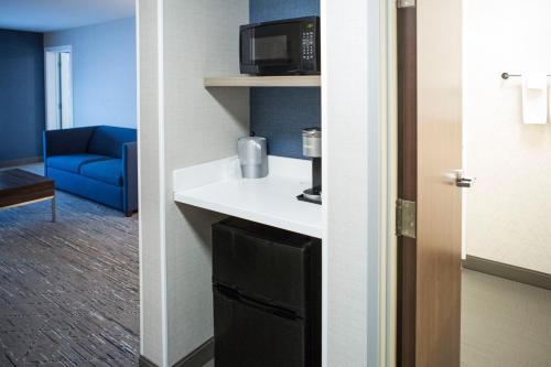 a room with a sink and a microwave at Holiday Inn Express & Suites Prince Albert - South by IHG in Prince Albert