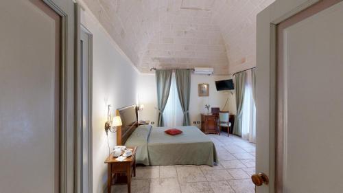 Ένα ή περισσότερα κρεβάτια σε δωμάτιο στο Relais Reggia Domizia