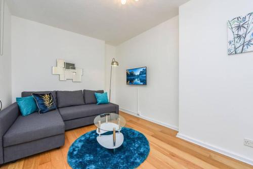 a living room with a couch and a table at Central London- 1 Bed Apartment! in London