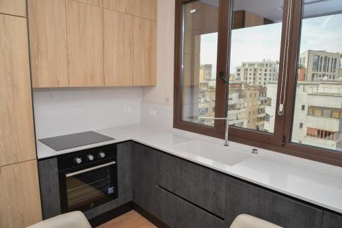 a kitchen with a view of a city at Signature apartment 8 in Tirana
