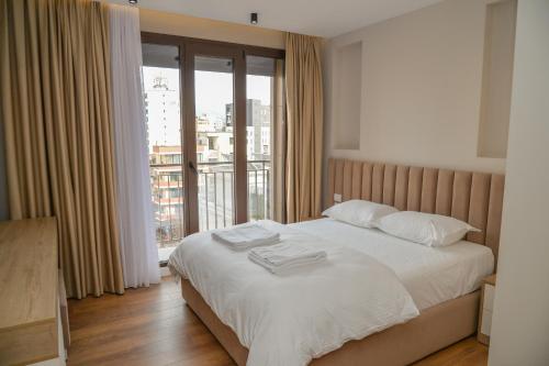 a bedroom with a bed with two towels on it at Signature apartment 8 in Tirana