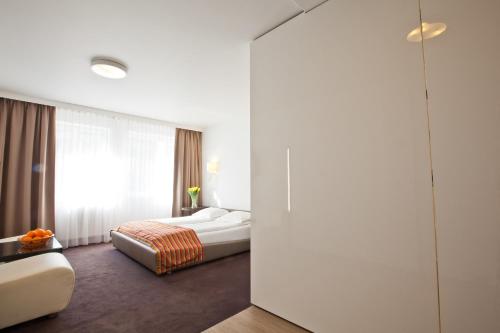 a hotel room with a bed and a large window at Platinum Apartments Aparthotel in Poznań