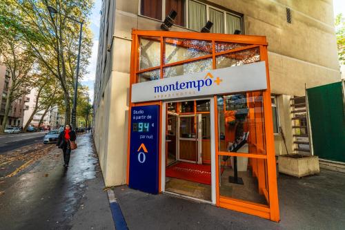 a woman walking in front of a store at Résidence Montempô Part Dieu in Lyon