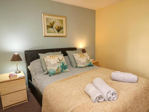 a bedroom with a bed with towels on it at Carew in Llandysul