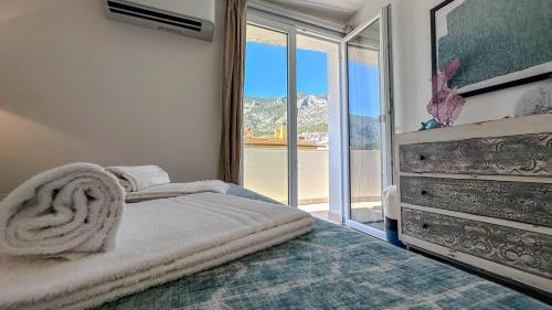 a bedroom with a bed and a large window at Casa Luna Blanca in Cala Gonone
