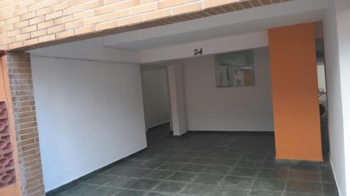 an empty room with white walls and a brick wall at Apartamento para Temporada Ubatuba in Ubatuba