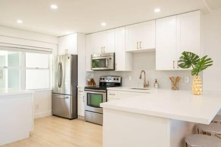 a kitchen with white cabinets and stainless steel appliances at La Brisa Unit 105 North Building in Key West