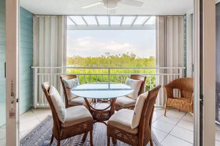 a patio with a table and chairs and a balcony at La Brisa Unit 105 North Building in Key West
