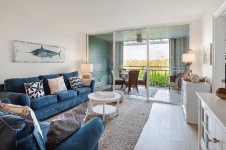 a living room with a blue couch and a table at La Brisa Unit 105 North Building in Key West
