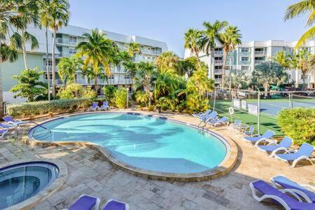 a large swimming pool with lounge chairs and a building at La Brisa Unit 105 North Building in Key West