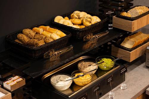 a buffet with baskets of bread and other foods at Onyx Luxury Budapest in Budapest