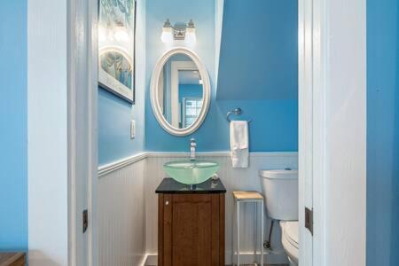 a blue bathroom with a sink and a toilet at Road's End by Brightwild in Key West