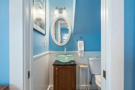 a blue bathroom with a sink and a toilet at Road's End in Key West