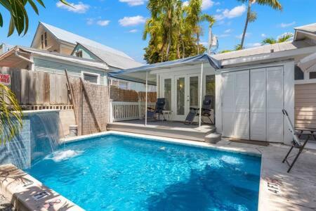 a swimming pool in front of a house at Poolside Suite in Key West