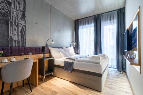a hotel room with a bed and a desk and a desk at Onyx Luxury Budapest in Budapest