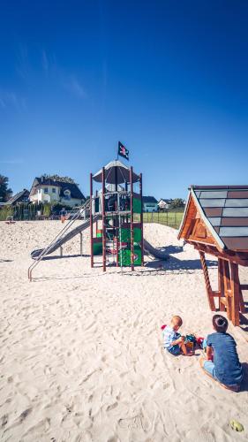 two children playing in the sand at a playground at Hotel Kalenborner Höhe in Kalenborn