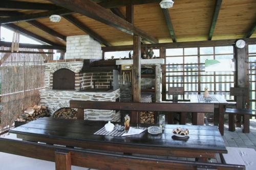 a large room with a table and a stone oven at Chalupa Nemilkov in Velhartice