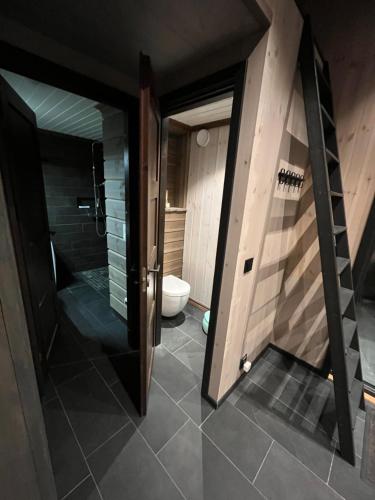 a bathroom with a walk in shower and a toilet at Gudbrandsdalen view cabin in Strande