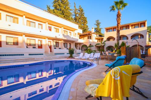 a hotel with a swimming pool in front of a building at Oscar Seaside Hotel & Spa in Bodrum City