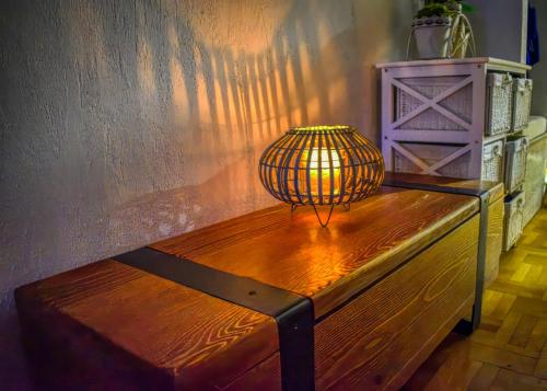 a lamp sitting on top of a wooden bench at Sea view Studio Terminal in Budva