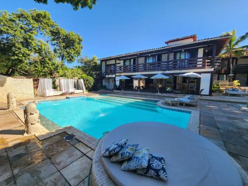 a swimming pool in front of a building at Pousada Blue Marlin in Búzios