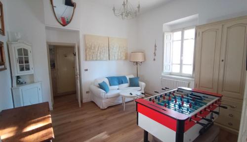 a living room with a foosball table in the middle of a room at Antico Chalet Momosa Maxi in Ovindoli