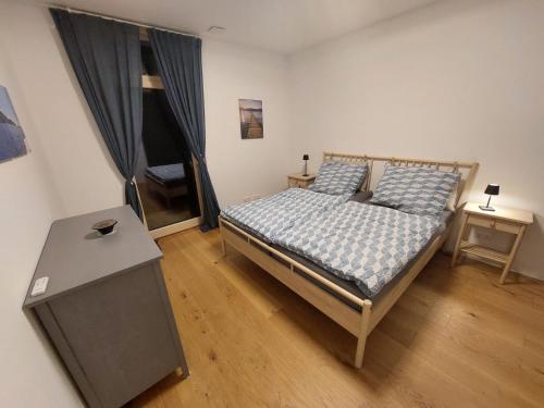a bedroom with a bed and a table in a room at Appartement am Teich in Hainfeld