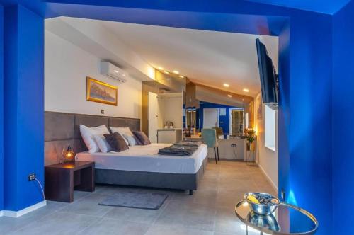 a bedroom with a large bed in a blue room at X Boutique Marinac Studio Apartments & Rooms in Šibenik