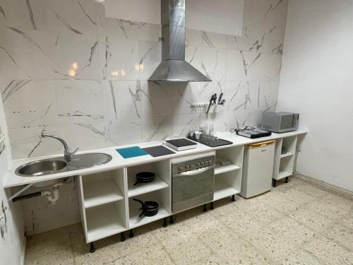 a kitchen with a sink and a counter top at BF BOUTIQUE JEREZ in Jerez de la Frontera
