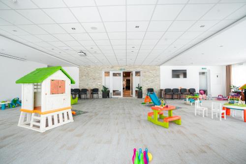 a room filled with lots of different colored tables and chairs at Šport Hotel *** Donovaly in Donovaly