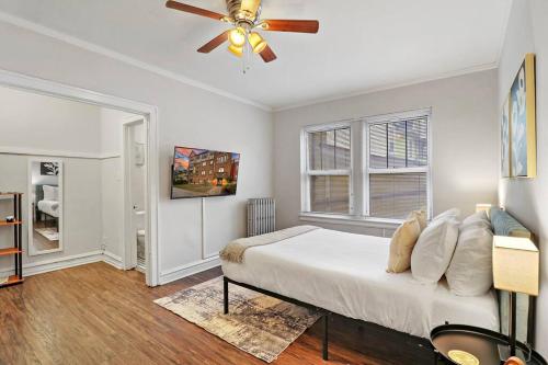 a bedroom with a bed and a ceiling fan at City Charm Studio Apt in Chicago - Kenwood 205 in Chicago
